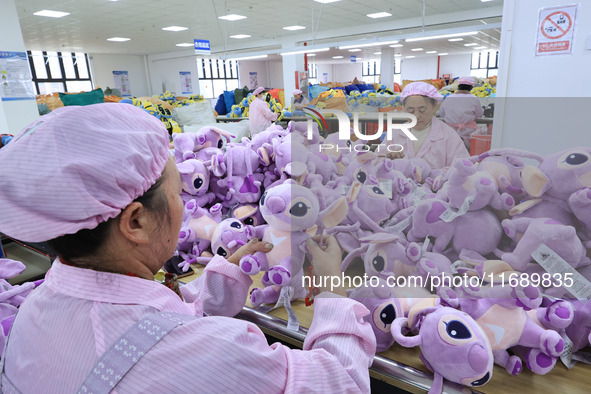 Workers rush to make plush toys for export at a toy company in Chengtou town, Ganyu district, Lianyungang, China, on October 21, 2024. 