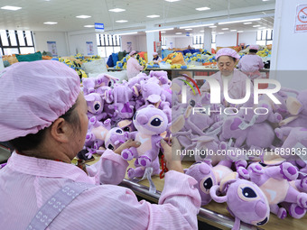 Workers rush to make plush toys for export at a toy company in Chengtou town, Ganyu district, Lianyungang, China, on October 21, 2024. (