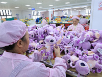 Workers rush to make plush toys for export at a toy company in Chengtou town, Ganyu district, Lianyungang, China, on October 21, 2024. (