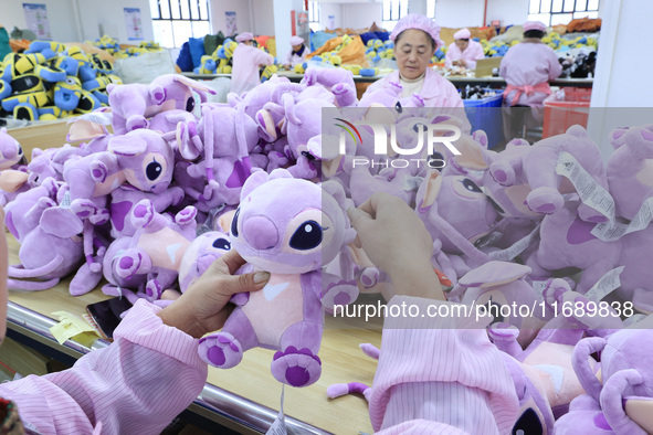 Workers rush to make plush toys for export at a toy company in Chengtou town, Ganyu district, Lianyungang, China, on October 21, 2024. 