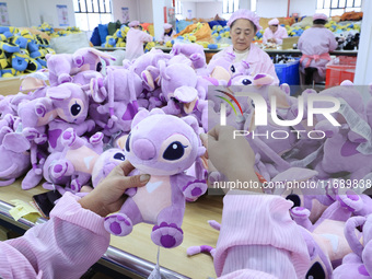 Workers rush to make plush toys for export at a toy company in Chengtou town, Ganyu district, Lianyungang, China, on October 21, 2024. (