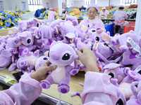 Workers rush to make plush toys for export at a toy company in Chengtou town, Ganyu district, Lianyungang, China, on October 21, 2024. (