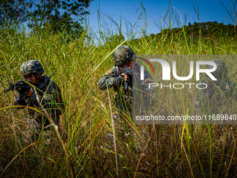 People's Armed Police conduct a mountain and forest combat drill in Qinzhou, China, on October 20, 2024. (