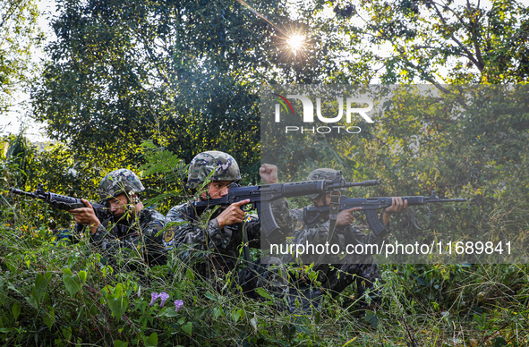 People's Armed Police conduct a mountain and forest combat drill in Qinzhou, China, on October 20, 2024. 