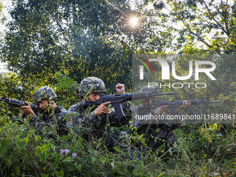 People's Armed Police conduct a mountain and forest combat drill in Qinzhou, China, on October 20, 2024. (