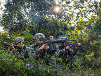 People's Armed Police conduct a mountain and forest combat drill in Qinzhou, China, on October 20, 2024. (