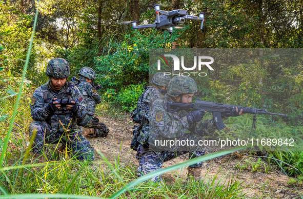 People's Armed Police conduct a mountain and forest combat drill in Qinzhou, China, on October 20, 2024. 