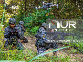 People's Armed Police conduct a mountain and forest combat drill in Qinzhou, China, on October 20, 2024. (