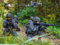 People's Armed Police conduct a mountain and forest combat drill in Qinzhou, China, on October 20, 2024. (