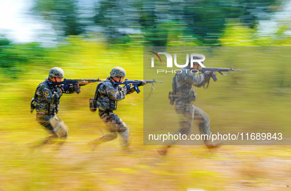 People's Armed Police conduct a mountain and forest combat drill in Qinzhou, China, on October 20, 2024. 