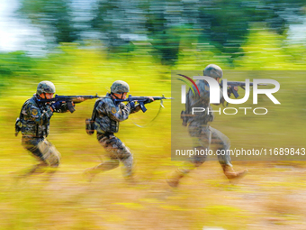 People's Armed Police conduct a mountain and forest combat drill in Qinzhou, China, on October 20, 2024. (