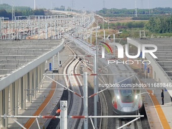 The first train of the Weifang-Yantai High-Speed Railway enters Laizhou Station in Shandong province in Yantai, China, on October 21, 2024....