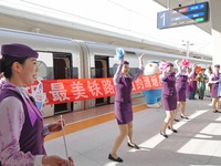 Railway workers promote cultural tourism at Laizhou Railway Station in Yantai, China, on October 21, 2024. (