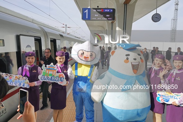 Railway workers promote cultural tourism at Laizhou Railway Station in Yantai, China, on October 21, 2024. 