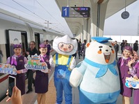 Railway workers promote cultural tourism at Laizhou Railway Station in Yantai, China, on October 21, 2024. (