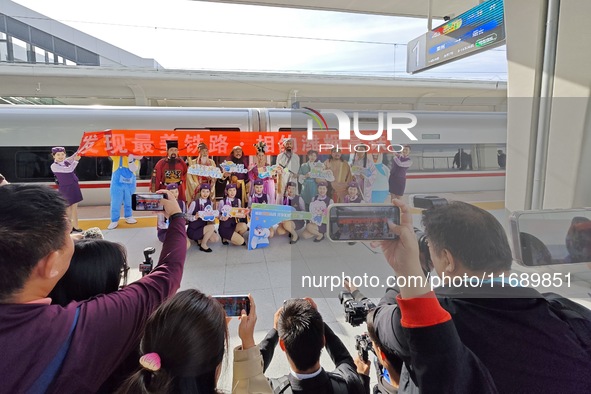 Railway workers promote cultural tourism at Laizhou Railway Station in Yantai, China, on October 21, 2024. 