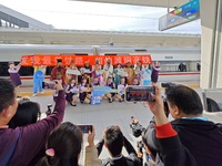 Railway workers promote cultural tourism at Laizhou Railway Station in Yantai, China, on October 21, 2024. (