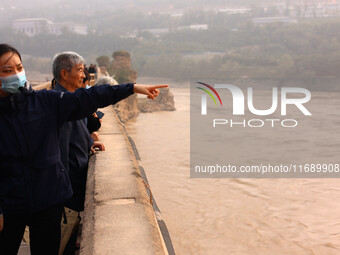 Tourists visit the Sanmenxia Dam in Sanmenxia, China, on October 21, 2024. (