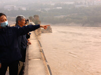 Tourists visit the Sanmenxia Dam in Sanmenxia, China, on October 21, 2024. (