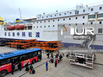 Passengers board a ferry after customs clearance at Lianyungang International Passenger Station in Lianyungang, China, on October 21, 2024....