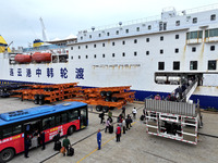 Passengers board a ferry after customs clearance at Lianyungang International Passenger Station in Lianyungang, China, on October 21, 2024....