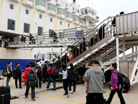 Passengers board a ferry after customs clearance at Lianyungang International Passenger Station in Lianyungang, China, on October 21, 2024....