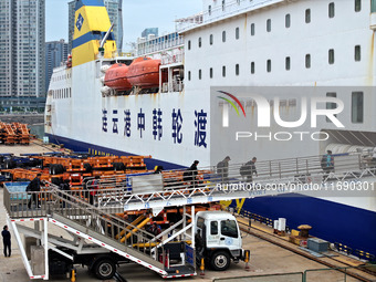 Passengers board a ferry after customs clearance at Lianyungang International Passenger Station in Lianyungang, China, on October 21, 2024....