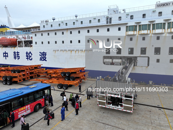 Passengers board a ferry after customs clearance at Lianyungang International Passenger Station in Lianyungang, China, on October 21, 2024....