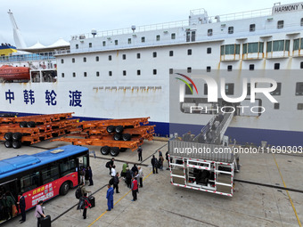 Passengers board a ferry after customs clearance at Lianyungang International Passenger Station in Lianyungang, China, on October 21, 2024....