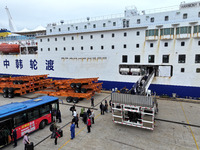 Passengers board a ferry after customs clearance at Lianyungang International Passenger Station in Lianyungang, China, on October 21, 2024....