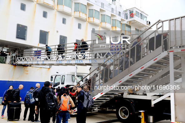 Passengers board a ferry after customs clearance at Lianyungang International Passenger Station in Lianyungang, China, on October 21, 2024....