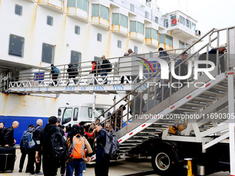 Passengers board a ferry after customs clearance at Lianyungang International Passenger Station in Lianyungang, China, on October 21, 2024....