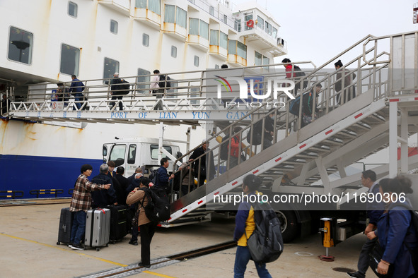 Passengers board a ferry after customs clearance at Lianyungang International Passenger Station in Lianyungang, China, on October 21, 2024....