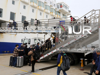 Passengers board a ferry after customs clearance at Lianyungang International Passenger Station in Lianyungang, China, on October 21, 2024....