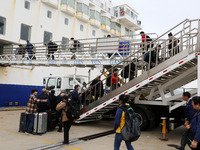 Passengers board a ferry after customs clearance at Lianyungang International Passenger Station in Lianyungang, China, on October 21, 2024....