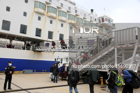 Passengers board a ferry after customs clearance at Lianyungang International Passenger Station in Lianyungang, China, on October 21, 2024....