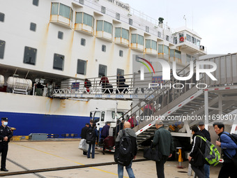 Passengers board a ferry after customs clearance at Lianyungang International Passenger Station in Lianyungang, China, on October 21, 2024....