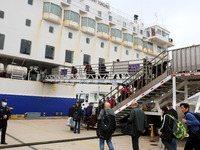 Passengers board a ferry after customs clearance at Lianyungang International Passenger Station in Lianyungang, China, on October 21, 2024....