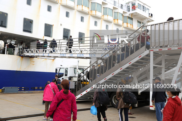 Passengers board a ferry after customs clearance at Lianyungang International Passenger Station in Lianyungang, China, on October 21, 2024....