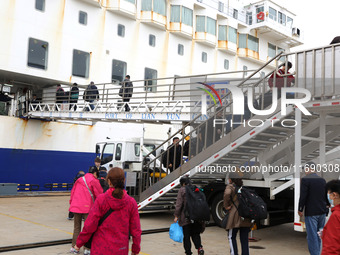 Passengers board a ferry after customs clearance at Lianyungang International Passenger Station in Lianyungang, China, on October 21, 2024....