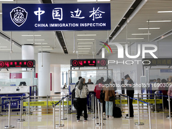 Passengers board a ferry after customs clearance at Lianyungang International Passenger Station in Lianyungang, China, on October 21, 2024....