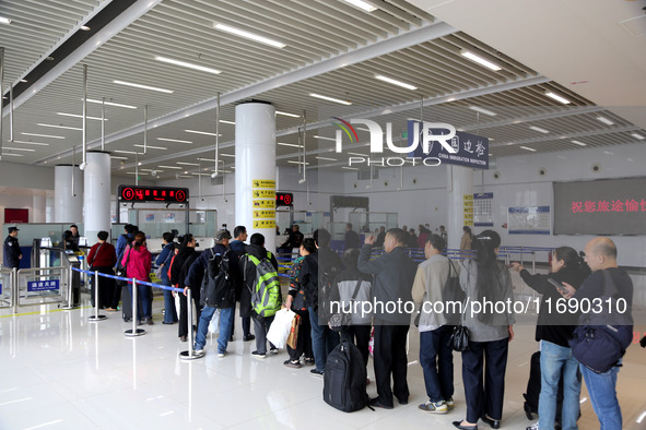 Passengers board a ferry after customs clearance at Lianyungang International Passenger Station in Lianyungang, China, on October 21, 2024....