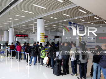 Passengers board a ferry after customs clearance at Lianyungang International Passenger Station in Lianyungang, China, on October 21, 2024....