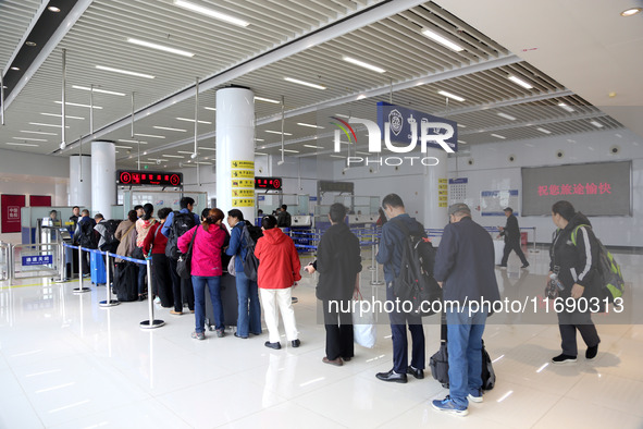 Passengers board a ferry after customs clearance at Lianyungang International Passenger Station in Lianyungang, China, on October 21, 2024....