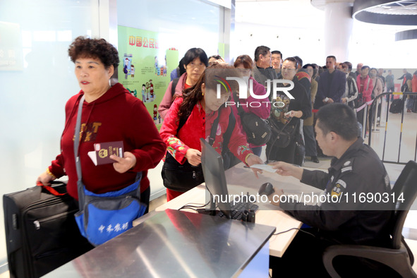 Passengers board a ferry after customs clearance at Lianyungang International Passenger Station in Lianyungang, China, on October 21, 2024....