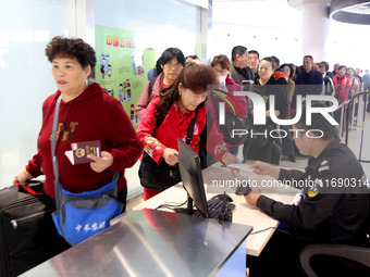 Passengers board a ferry after customs clearance at Lianyungang International Passenger Station in Lianyungang, China, on October 21, 2024....