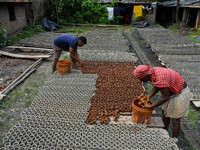 Workers dry clay pots, which are made for sale ahead of the Diwali festival celebration in Kolkata, India, on October 21, 2024. (