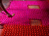 Workers apply colors to clay oil lamps, which are made for sale ahead of the Diwali festival celebration in Kolkata, India, on October 21, 2...