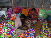 Workers apply final touches to clay oil lamps, which are made for sale ahead of the Diwali festival celebration in Kolkata, India, on Octobe...