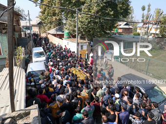 People carry the dead body of a doctor who is killed in an alleged militant attack in the Nadigam area of Budgam district, Indian-administer...